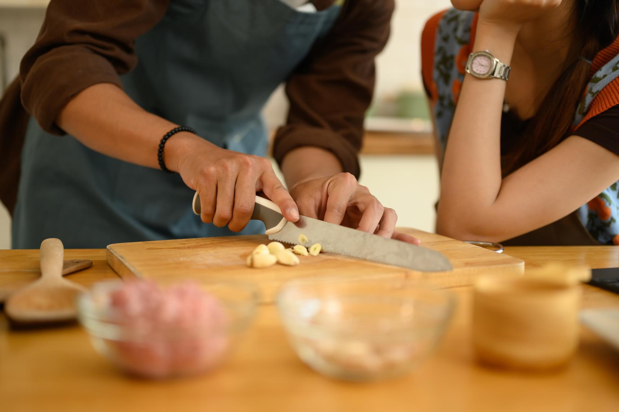 Workshop table with participants learning knife skills